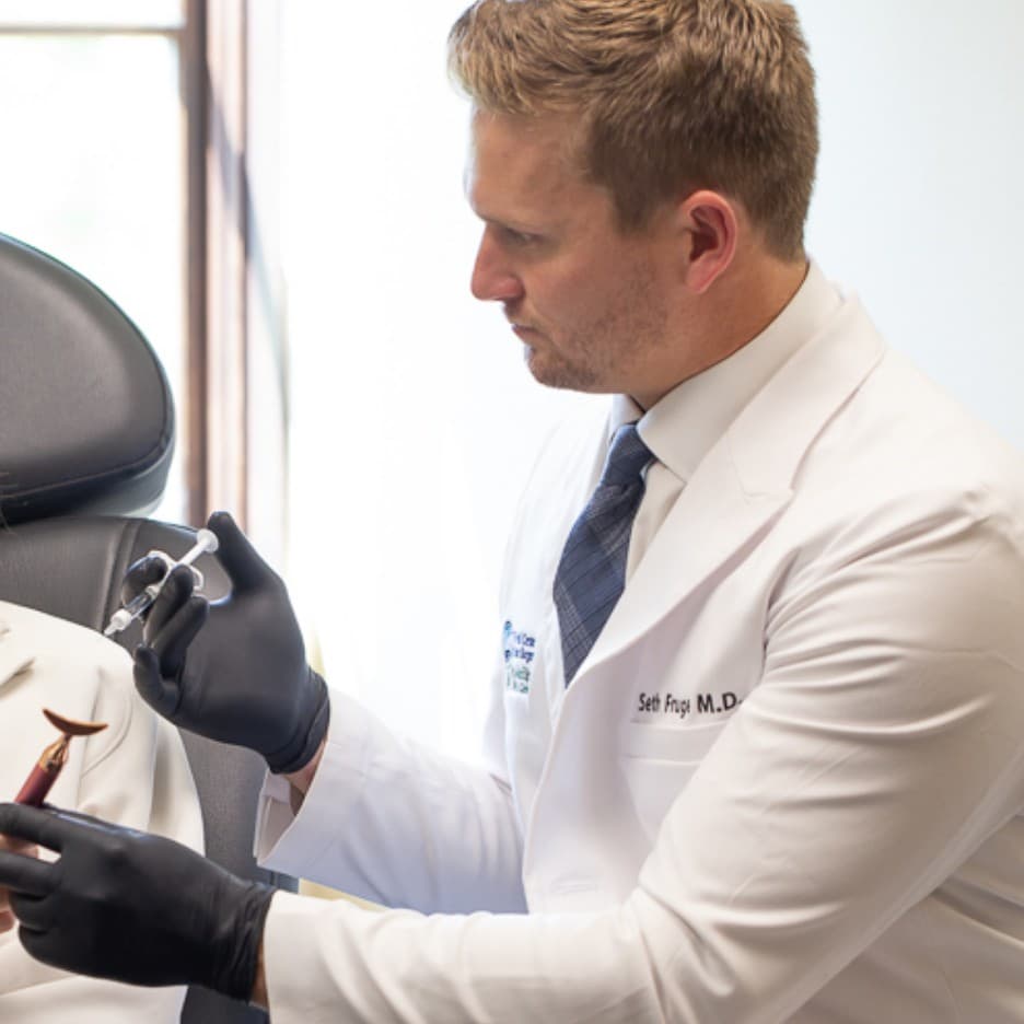 Professional portrait of Seth Fruge, MD wearing a blue suit and tie.