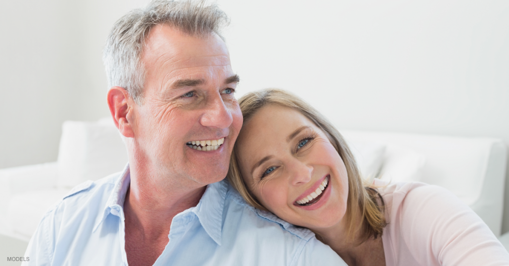 Middle aged man and woman smiling