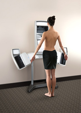 Rear view of woman without top standing at Vectra machine