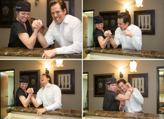 Dr. Holly Wall and Dr. Simeon Wall, Jr., playfully arm wrestle in their office