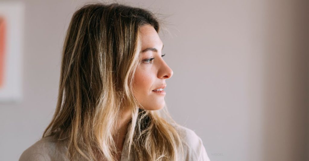 side profile of woman, showing off her post nose job results (MODEL)