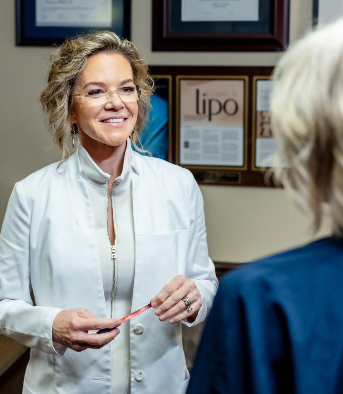 Holly Casey Wall, MD, FACS talking to patient