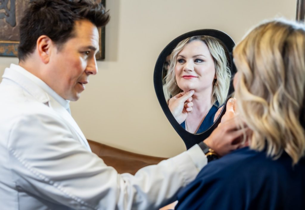 Dr. Wall examining patients face