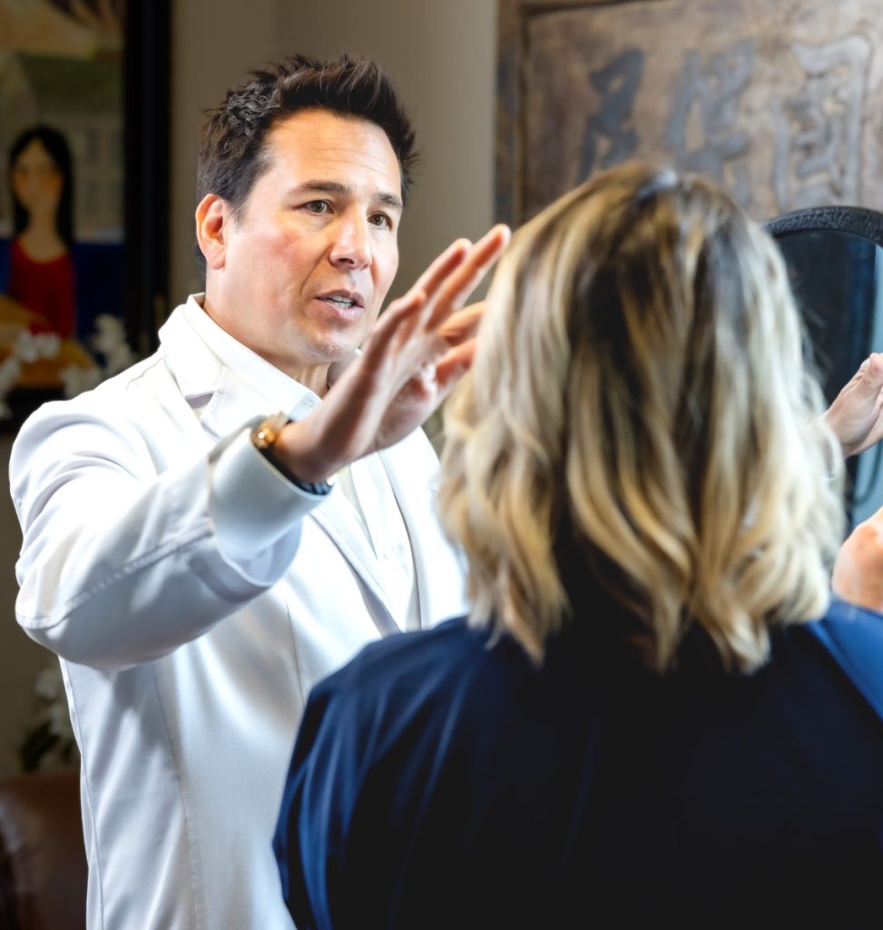 Dr. Simeon Wall Jr. pointing on patients face